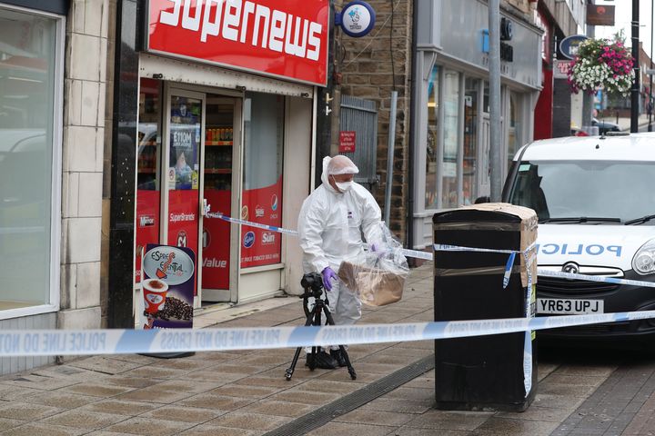 A forensic officer check a bin in Peel Square in Barnsley town centre after the serious incident.