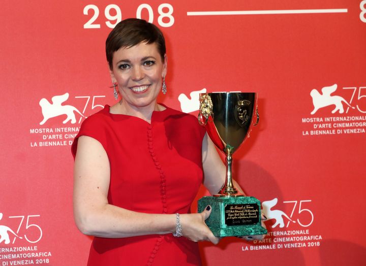 Olivia Colman poses with the Coppa Volpi