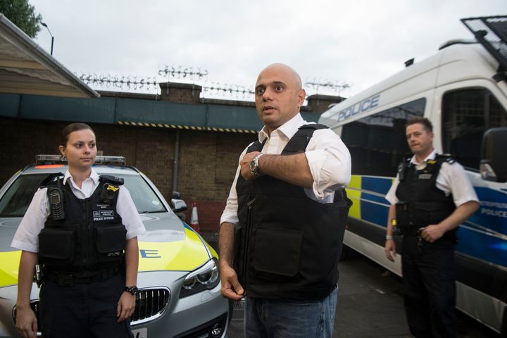 Home Secretary Sajid Javid puts on a stab proof vest during a visit to a north London police station 
