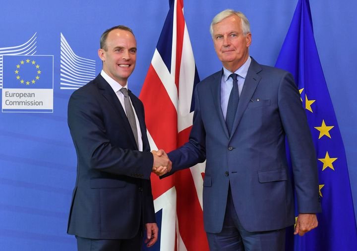 EU Chief Brexit Negotiator Michel Barnier (R) shakes hands with Britain's Brexit Secretary Dominic Raab during their meeting at the European Commission in Brussels on August 31, 2018