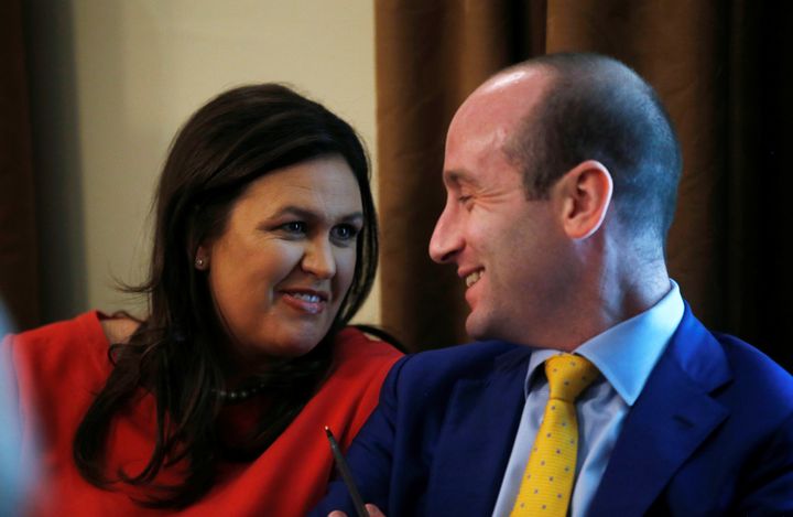 White House press secretary Sarah Huckabee Sanders laughs with White House senior adviser Stephen Miller during a cabinet meeting in July.