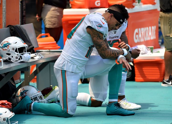 Miami Dolphins wide receiver Kenny Stills (left) and Dolphins wide receiver Albert Wilson (right) both kneel during the national anthem prior to a game against the Tennessee Titans at Hard Rock Stadium in Miami Gardens, Fla., Sunday.