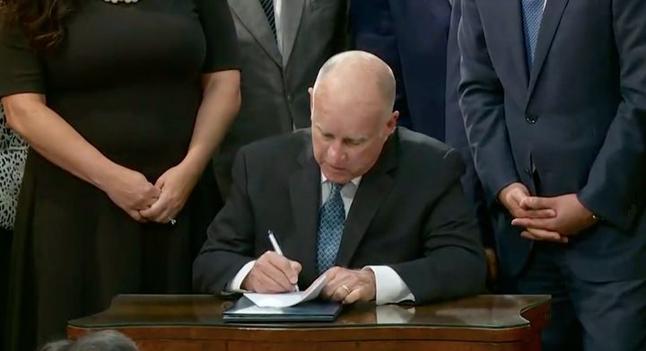 Gov. Jerry Brown signs into law California’s ambitious new emissions targets on Sept. 10.