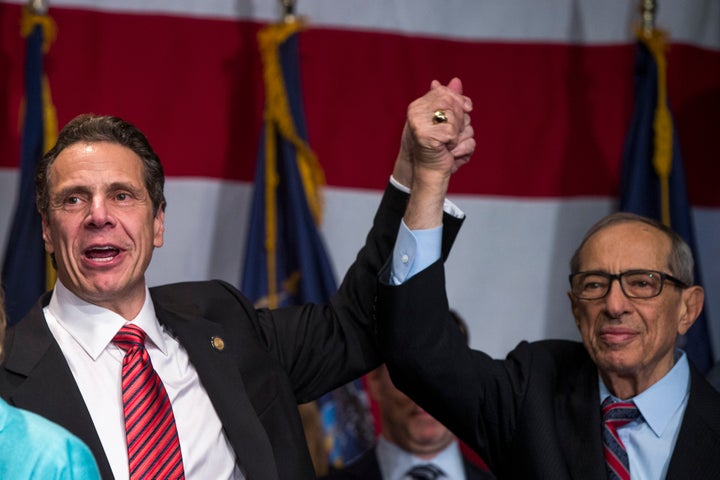 Democratic New York Gov. Andrew Cuomo (left) celebrates with his father, former Gov. Mario Cuomo, after winning a second term