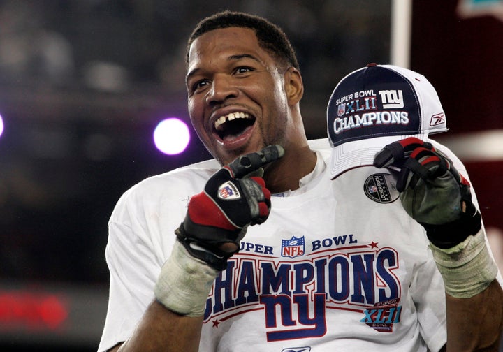 New York Giants defensive end Michael Strahan celebrates after his team's win over the Patriots in the Super Bowl XLII game o