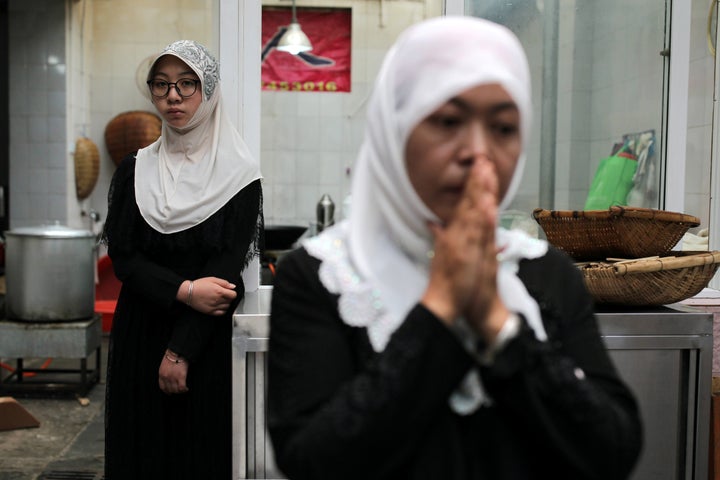 Women stand at a kitchen near a mosque during the Muslim holiday Eid al-Adha, in Kunming, Yunnan province, China August 22, 2018.
