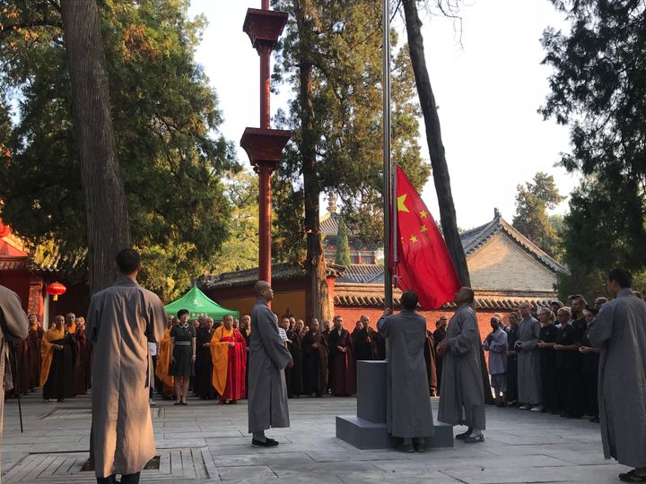 Monks raise the Chinese national flag during a ceremony at Shaolin Temple on August 27, 2018 in Zhengzhou, China. It is the temple's first national flag raising ceremony since its establishment in 495. 