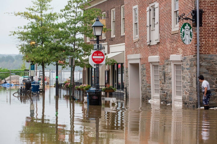Heavy rain flooded the streets of Old Town Alexandria, Virginia, on Tuesday as sandbags were being distributed to businesses
