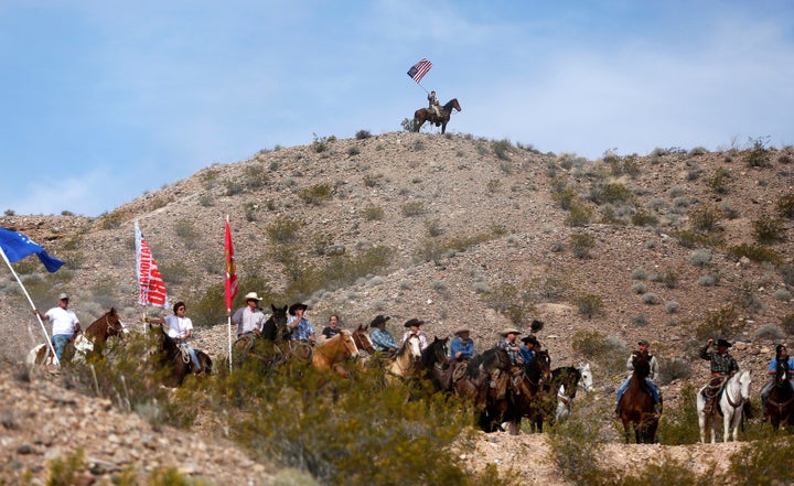 Protesters on horseback ride on the hills above a rally site in Bunkerville, Nevada, April 12, 2014.