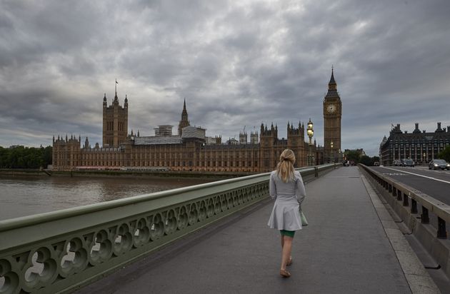 A woman walks on Westminster Bridge towards the Houses of Parliament (file picture) 