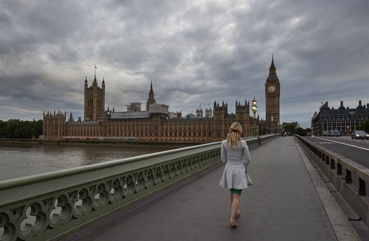 A woman walks on Westminster Bridge towards the Houses of Parliament (file picture) 