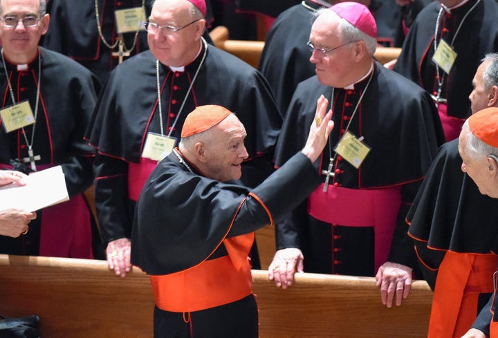 Former Cardinal Theodore McCarrick waves to fellow bishops as attends the midday prayer service at the Cathedral of St. Matth