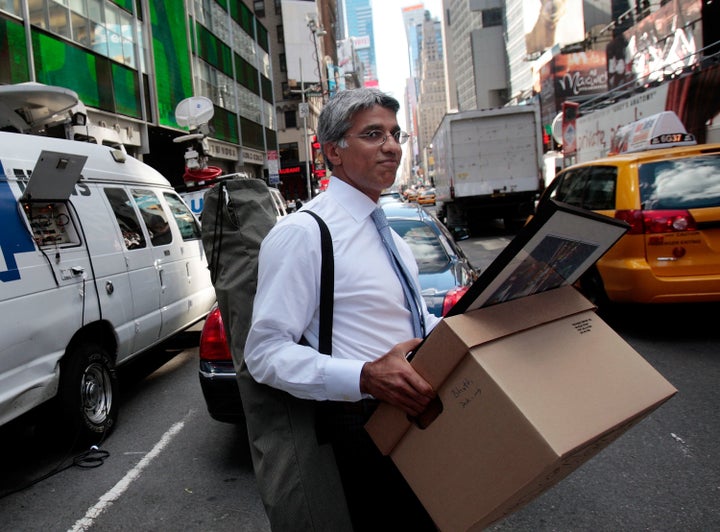 An employee of Lehman Brothers Holdings Inc. carries a box out of the company's headquarters building on Sept. 15, 2008, in New York City. 