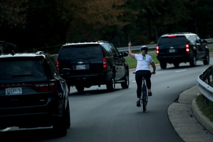 Juli Briskman gestures with her middle finger as President Donald Trump's motorcade passes her in October 2017.