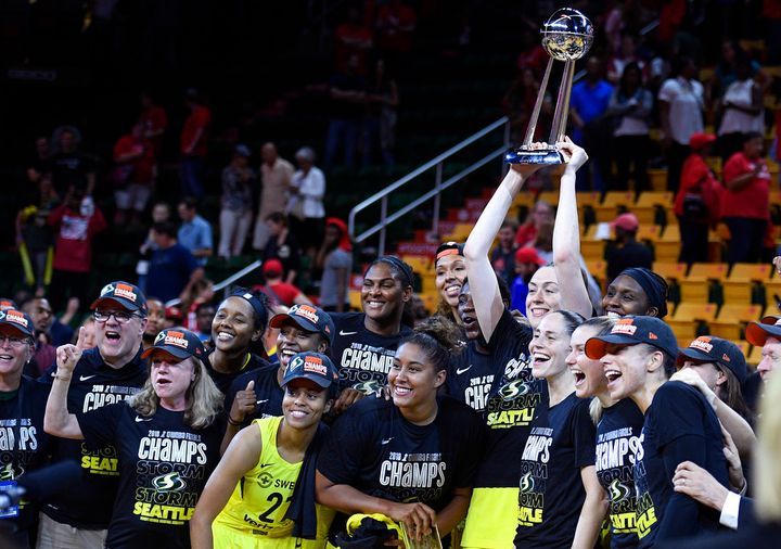 Seattle Storm forward Breanna Stewart holds and poses with the trophy with her teammates after Game 3 of the WNBA basketball finals against the Washington Mystics, Wednesday, Sept. 12, 2018, in Fairfax, Va. The Storm won 98-82 and the title. (AP Photo/Nick Wass)