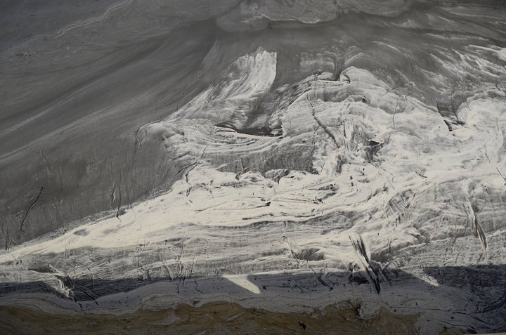 Swirls of coal ash in eddies and waters appear gray in the Dan River in Danville, Virginia, downstream from the Dan River Steam Station in Eden, North Carolina. 