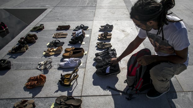 A demonstrator places an empty pair of shoes on display outside the Capitol building during a protest against the government's reporting of the death toll from  Hurricane Maria in San Juan, Puerto Rico, on Friday, June 1, 2018. Hurricane Maria probably killed about 5,000 people in Puerto Rico last year even though the official count remains at just 64, according to a Harvard University study released Tuesday. Photographer: Xavier Garcia/Bloomberg via Getty Images