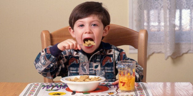 Young boy eating breakfast