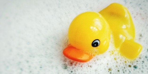 Close-Up Of Rubber Duck Floating On Bathtub