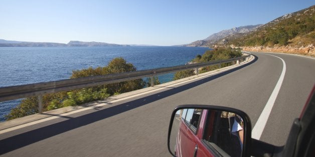 Drivers view of road and coast driving down the Croatian coast