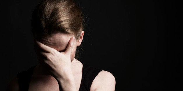 Young Woman With Face In Hands.