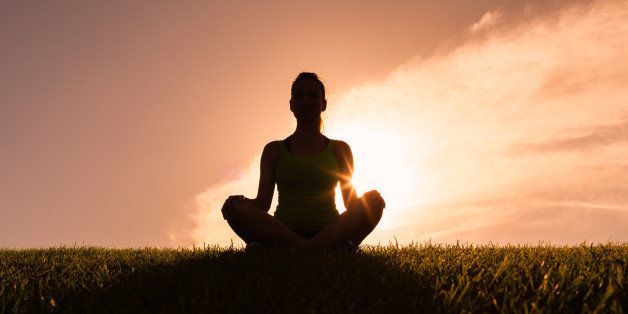 Woman meditating in yoga pose.