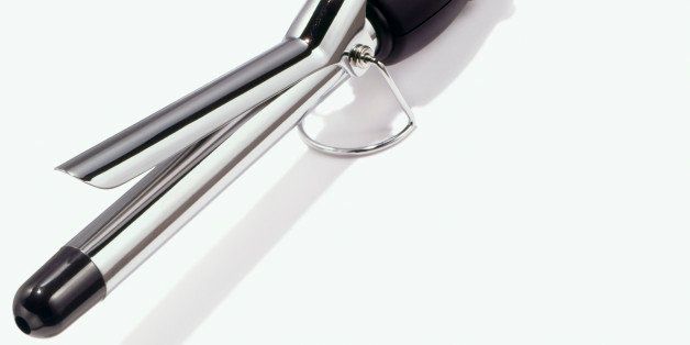 Hair curling iron on white background