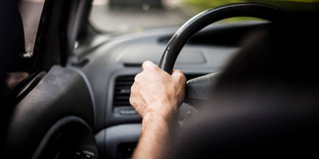 Man's hand driving car