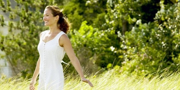 Smiling woman standing in field