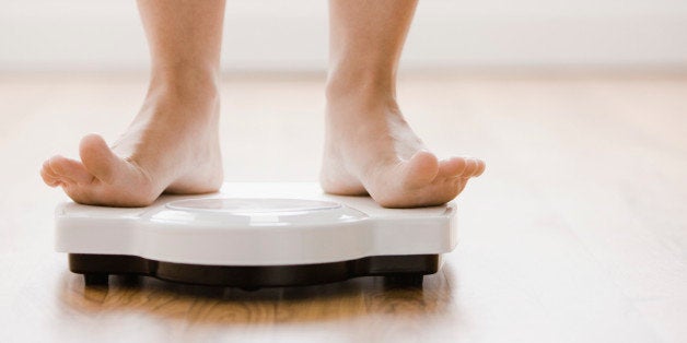 Caucasian woman's feet standing on scale