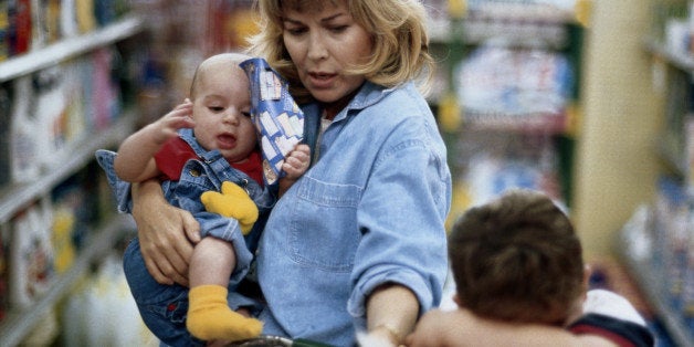 Mother and two children (1-6) shopping in supermarket