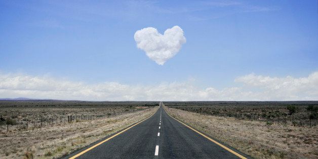 Remote road with heart shaped cloud over it.