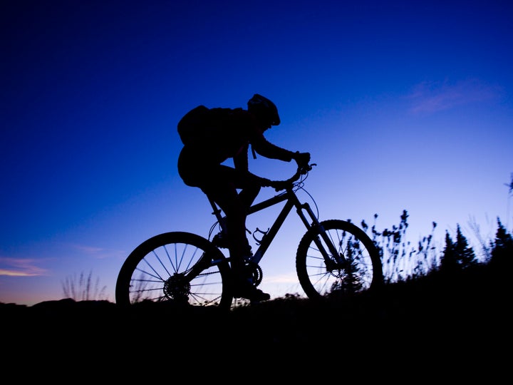 mountain bikers riding along a trail