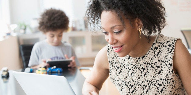 Mixed race businesswoman working at home