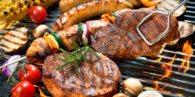 Assorted delicious grilled meat with vegetable over the coals on a barbecue