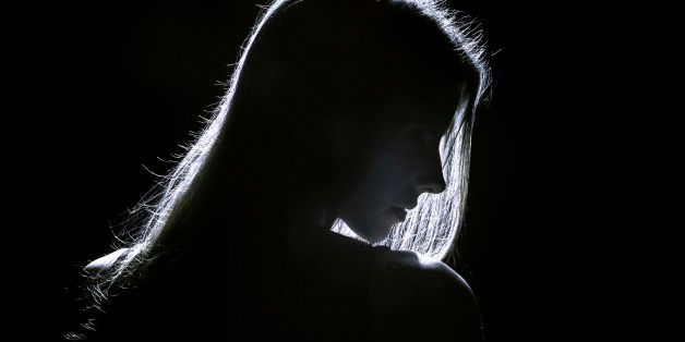 sad woman profile silhouette in dark