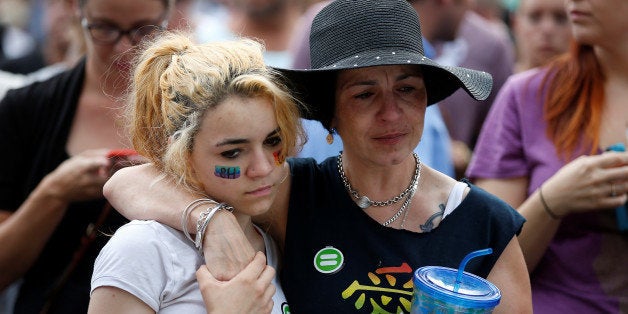 People attend a memorial service the day after a mass shooting at the Pulse gay nightclub in Orlando, Florida, U.S. June 13, 2016. REUTERS/Carlo Allegri