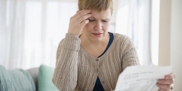 Anxious Caucasian woman paying bills