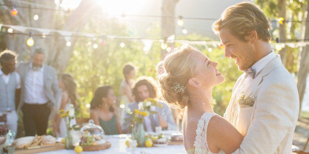 Young couple dancing during wedding reception in domestic garden