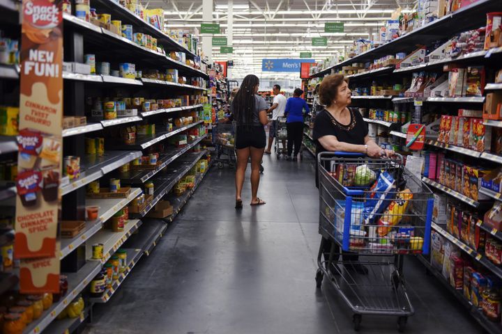 Shoppers walk through a depleted canned food aisle in a Walmart store in Charlotte, North Carolina, as residents prepare Thursday for Hurricane Florence.