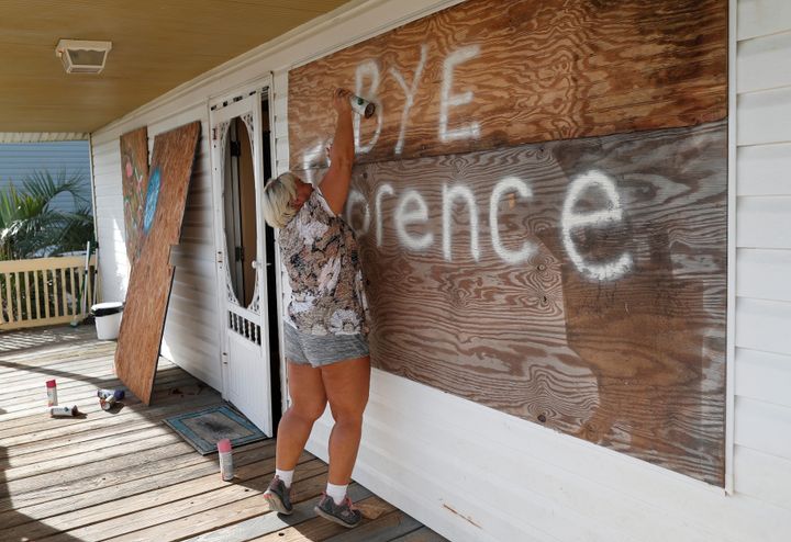 Lisa Evers of Oak Island, North Carolina, decorates her storm shutters before evacuating her house ahead of the arrival of Hurricane Florence.