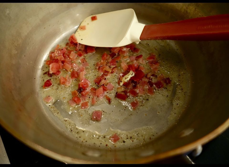 Gently cooking speck in butter - with pepper