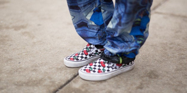 Chloe Snower is seen on Michigan Avenue wearing checker & cherry Vans shoes, blue patterned Maria Ke Fishermen pants, striped vintage jacket, Miu Miu glasses, red Proenza Schouler backpack, with a Moschino phone cover on January 7, 2016 in Chicago, Illinois. (Photo by Matthew Sperzel/Getty Images)