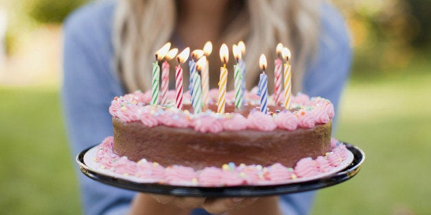 USA, Utah, Provo, Mid-section of young woman holding birthday cake