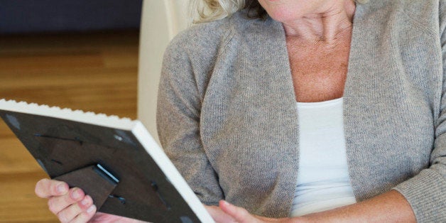 Woman looking at a picture frame