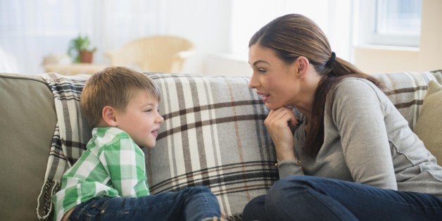 Mother and son (6-7) sitting on sofa