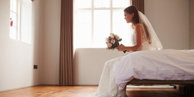 Bride In Bedroom Having Second Thoughts Before Wedding