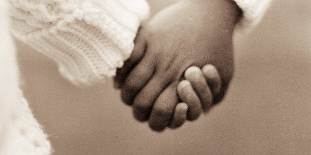 Two young children holding hands