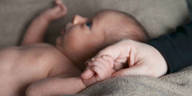 (GERMANY OUT) A young mother holds the hand of her newborn son (Photo by JOKER / Gudrun Petersen/ullstein bild via Getty Images)