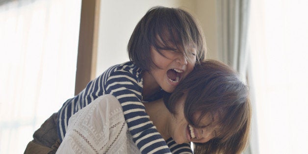 Mother giving daughter a piggyback ride,Girl of five years,Japan